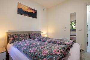 a bedroom with a bed with a colorful bedspread at Casa Maria Lake View in Brenzone sul Garda