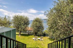 two chairs sitting in a yard with trees at Casa Maria Lake View in Brenzone sul Garda