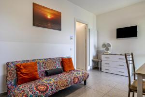 a living room with a couch and a television at Casa Maria Lake View in Brenzone sul Garda