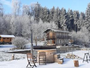 une maison avec une table et des chaises dans la neige dans l'établissement White wood, à Darney