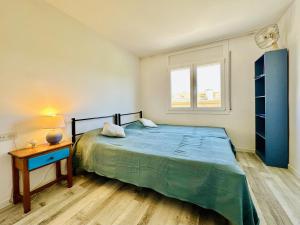 a bedroom with a bed and a table and a window at Mimoses CostaBravaSi in Sant Feliu de Guíxols +40 photos