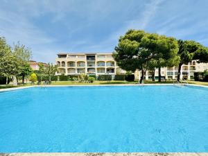a large blue swimming pool in front of a building at Mimoses CostaBravaSi in Sant Feliu de Guíxols