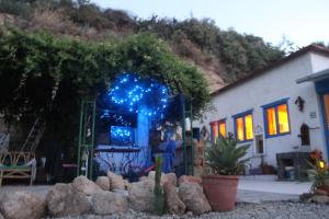a house with blue lights in a yard at A peaceful country house in Tenerife in Fasnia