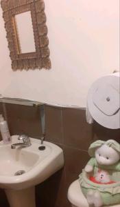 a bathroom with a sink and a toilet and a mirror at Casa Campestre en una comunidad tradicional en la naturaleza 1 in San Juan de Ilumán