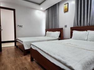 Säng eller sängar i ett rum på Khách sạn Ngọc Châu