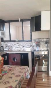 a kitchen with a table and a counter top at Casa Campestre en una comunidad tradicional en la naturaleza 1 in San Juan de Ilumán