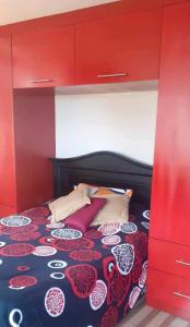 a bedroom with a bed with a red canopy at Casa Campestre en una comunidad tradicional en la naturaleza 1 in San Juan de Ilumán