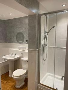 a bathroom with a shower and a toilet and a sink at Middleton country retreat with airport parking . in Middleton One Row