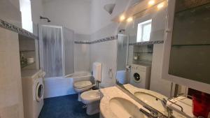a white bathroom with a sink and a toilet at La Terrazza sul Mare Sea View - near best beaches in Monterosso al Mare +29 photos