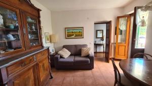 a living room with a chair and a table at La Terrazza sul Mare Sea View - near best beaches in Monterosso al Mare
