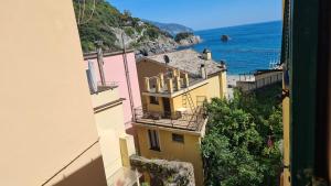 a view of a building with the ocean in the background at La Terrazza sul Mare Sea View - near best beaches in Monterosso al Mare