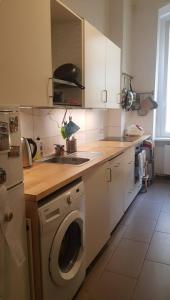 a kitchen with a sink and a washing machine at Cozy room in Neukölln , Kreuzberg in Berlin