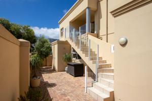 a house with stairs on the side of it at Ocean View living in Hermanus