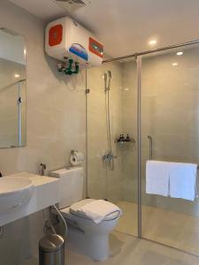 a bathroom with a shower and a toilet and a sink at Mandala Apartment Hotel in Bắc Ninh