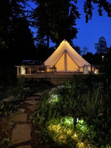 a white tent in a garden at night at Urshult Glamping in Urshult