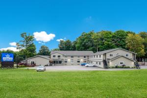 un grande edificio con auto parcheggiate in un parcheggio di Americas Best Value Inn Marquette a Marquette