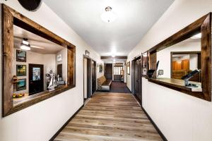 a hallway of a house with wooden floors at Americas Best Value Inn Marquette in Marquette