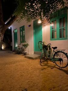 a bike parked in front of a house at night at Fins Arugambay in Arugam Bay