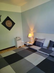 a bedroom with a bed and a checkered floor at Dreamapartment 4 Roomlake in Lugano