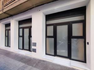 a row of four garage doors on a building at Apartamento Río Turia B in Valencia