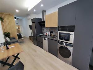a kitchen with a stove and a table in a room at Apartamento Río Turia B in Valencia