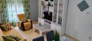 a living room with a tv in a cabinet at Jesús Del Perdón in Manzanares