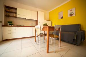 a kitchen with a table and chairs and a couch at Villaggio San Matteo Resort in Mattinata