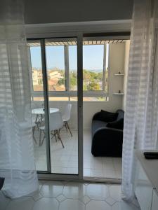 a living room with a couch and a table at Studio Antibes Port Vauban. in Antibes