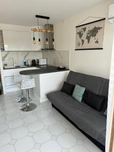 a living room with a couch and a kitchen at Studio Antibes Port Vauban. in Antibes