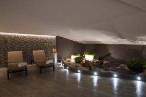 a lobby with two chairs and a fire place at Catalonia Atenas in Barcelona