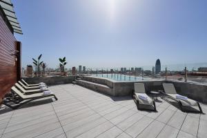 a patio with lounge chairs and a swimming pool at Catalonia Atenas in Barcelona
