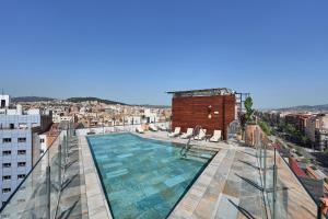 a swimming pool on the roof of a building at Catalonia Atenas in Barcelona