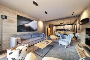 a living room with a couch and a table at Luxury Ski Chalet Andorra in Soldeu