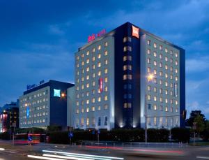 a tall building with a sign on top of it at ibis budget Warszawa Reduta in Warsaw
