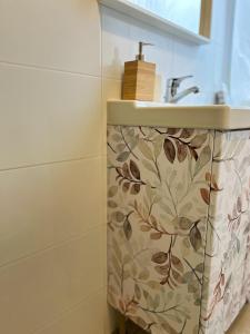 a bathroom with a sink and a shower curtain at Central Market Apartment in Calella