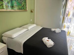 a bedroom with a bed with two towels on it at La Terrazza di Stefy in Acilia