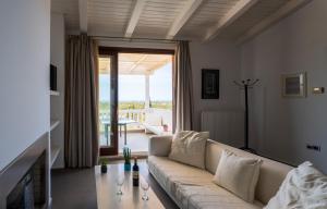 een woonkamer met een bank en een groot raam bij Krinos Suite-Magnificent Sea view in Chersonissos