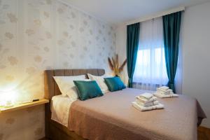 a bedroom with a bed with towels on it at Three-Bedroom Holiday Home in Dabar in Dabar