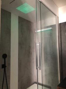 a shower with a green light on the ceiling at Villa Regina in Riva del Garda