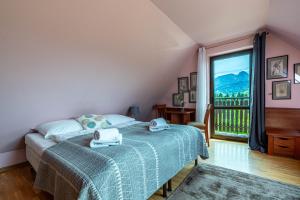 a bedroom with a bed and a large window at Willa ArtMontis in Kościelisko +152 photos