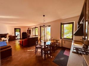 a living room with a table and a dining room at Incanto Nesso Parking and Lake View in Nesso