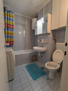 a bathroom with a toilet and a sink at Aura apartman Sarajevo in Sarajevo