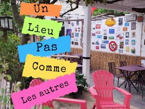 a group of chairs in front of a wall with signs at HOULALA Gîte & Chambres d'hôtes in Pont-Évêque