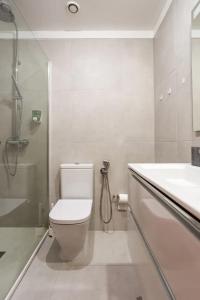 a bathroom with a shower and a toilet and a sink at Home Music Apartments in Porto