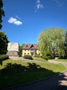 ein Haus mit einer Statue in einem Park in der Unterkunft Stara Piekarnia in Tylicz