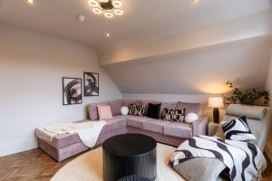 a living room with a couch and a table at Hearthside Park Road in Buxton