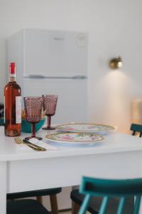 a table with two plates and a bottle of wine at Studios Eliza in Livadi