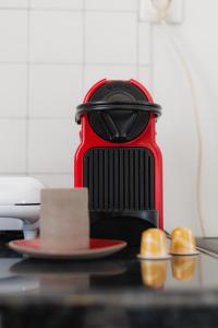 a red toaster sitting on a counter with a plate at Studios Eliza in Livadi
