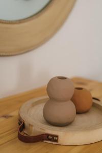 a stack of rocks sitting on a wooden table at Studios Eliza in Livadi