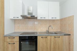 a kitchen with a sink and a stove at Perinic, No 1 in Vrsi +6 photos